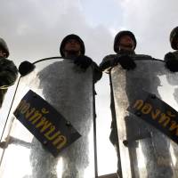 Thai soldiers block access to a meeting between Gen. Prayuth Chan-ocha and the country's rival political factions in central Bangkok on Thursday after the army seized control of the government in a coup. Japan firms hunker down after Thai coup