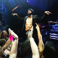 Worst dressed: Grammy-winning artist Macklemore wears a costume at a performance Friday. The artist apologized on his website after the outfit was interpreted by many to be an anti-Semitic caricature. Macklemore apologizes for offensive costume
