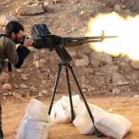 A rebel fighter fires in the direction of regime forces during clashes in the Sheikh Najar area of the restive Syrian city of Aleppo in February. Decisive battle looms for Syrian rebels in Aleppo