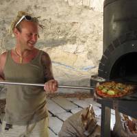 From the ground up: Dennis van den Brink makes a pizza with fresh vegetables in his stone oven at Niseko Green Farm. Farm life leads to healthy business for Dutch expat