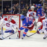 Blocked: New York’s Mats Zuccarello shoots between Montreal’s Dustin Tokarski (left) and Josh Gorges in Game 3 Thursday. Habs slip past Rangers in OT
