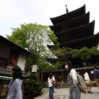 Tourists mill about in front of a five-story pagoda at a temple in Kyoto at the beginning of this month. Kyoto law puts 'upskirt' photography in focus