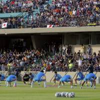 Japan soccer players take part in a training session at Sorocaba Municipal Stadium on Sunday. Thousands turn out to watch Japan's first practice session in Brazil