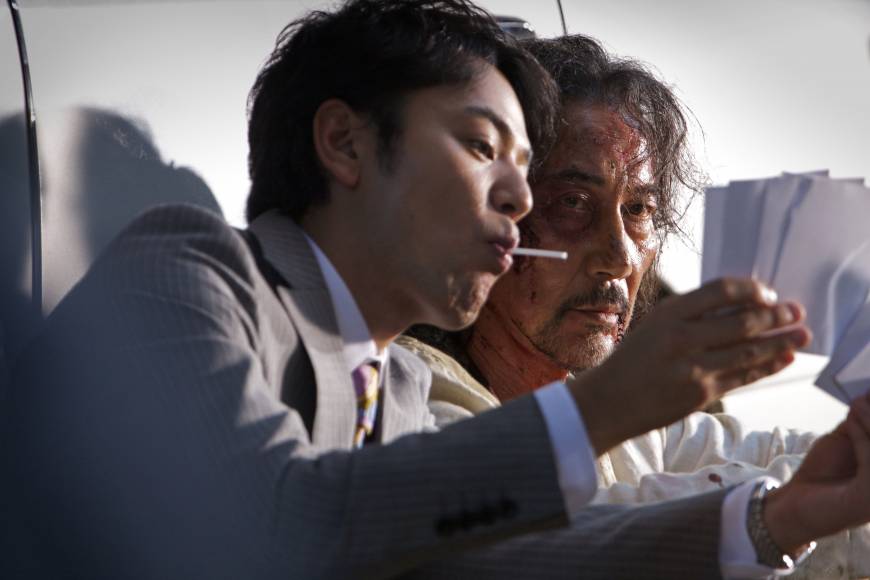 Hiding secrets: Akikazu Fujishima, played by Koji Yakusho (right), on the path of his hedonistic daughter, is approached by his former colleague, a lollipop-licking cop named Asai (Satoshi Tsumabuki).