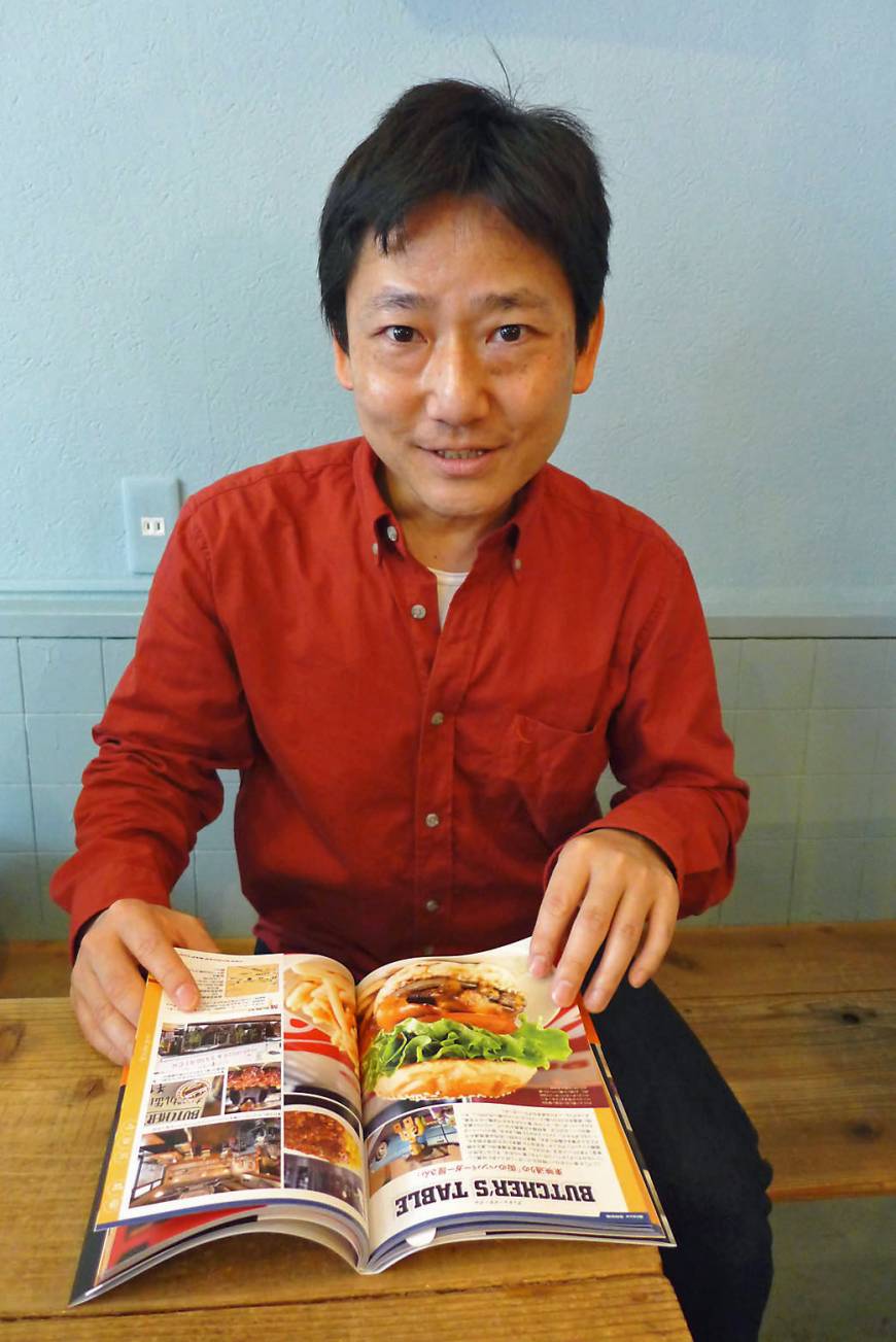 Burger Mania Burger king: Yoshihide Matsubara with his updated book, 'The Burger Map Tokyo.' | REBECCA MILNER