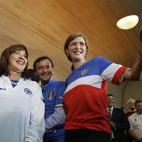 Sporting colors: U.S. Ambassador to the United Nations Samantha Powers (center) stands with Italian Ambassador Sebastiano Cardi (second from left), Bosnian Ambassador Mirsada Colakovic (left) and other representatives wearing their countries' soccer jerseys during a photo opportunity at U.N. headquarters in New York on June 9. Fashion critics have blasted the USA jersey, which is blue, white and red, for looking like a Domino's Pizza delivery uniform. Fashion experts weigh in on World Cup jersey style