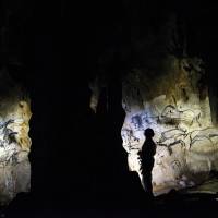 Curator Marie Bardisa examines part of Chauvet Cave, which now has UNESCO World Heritage status, in southern France. Time stands still in locked-off cave