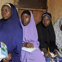 Maimuna Abdullahi (left) listens during class as she and others attend school in Kaduna, Nigeria, on June 2. Maimuna is one of thousands of divorced girls in Nigeria who were married as children and then got thrown out by their husbands or simply fled. Nigeria's epidemic: divorcee kids