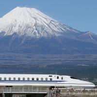 A bullet train runs past Mount Fuji on the Tokaido Shinkansen Line last November. Shinkansen tops list of 100 innovative postwar technologies