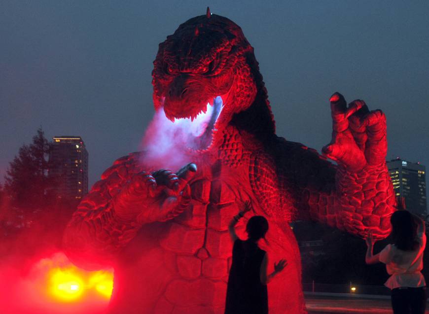 A 6.6-meter high model of Godzilla is illuminated Thursday at Tokyo Midtown’s garden in the Roppongi district to commemorate the 60th anniversary of the first “Godzilla’’ movie in 1954.