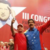 Venezuelan President Nicolas Maduro (right) embraces retired Gen. Hugo Carvajal as they attend the Socialist party congress in Caracas in this picture provided by Miraflores Palace on Sunday, after the ex-military intelligence chief flew home from detention in Aruba. Caracas threatened Aruba into freeing wanted Venezuelan general: U.S.