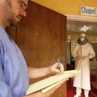 Dr. Kent Brantly (right), of Samaritan’s Purse relief organization, is shown in an undated photo wearing protective equipment as he gives orders for medication to Ebola patients, at the ELWA Hospital in Monrovia, Liberia. Brantly, a 33-year-old American doctor, tested positive for Ebola on Saturday. Ebola fears spread after infected man flies to Nigeria