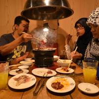 Muslim tourists from Thailand enjoy halal-certified food at a tabletop barbecue restaurant in Tokyo on June 24. Halal whale meat on menu as Japan tries to boost Muslim tourism