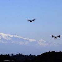 A pair of MV-22B Osprey aircraft fly in view of Mount Rainier during a flight for media members on Monday in Seattle. Osprey aircraft deployed at the U.S. Marine Corps’ Futenma Air Station in Okinawa Prefecture will take part in a tsunami disaster drill in Wakayama Prefecture in October. U.S. Ospreys to take part in Japan tsunami drill in October