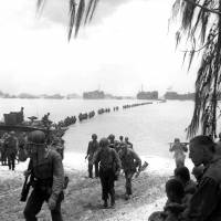 This July 1944 file photo shows U.S. Army reinforcement troops making an amphibious landing on the coral reef at Saipan. Japanese searching U.S. archives for WWII MIA info