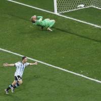 Agony and ecstasy: Argentina’s Maxi Rodriguez celebrates after his decisive penalty kick in the shootout against Jasper Cillessen of the Netherlands on Wednesday night in Sao Paulo. Argentina won 4-2 after a scoreless draw through extra time. Argentina advances to final with dramatic shootout win