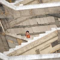 A Yazidi boy who fled when Islamic State militants attacked the Iraqi town of Sinjar sits in an unfinished structure where he has taken refuge near Dohuk, in Iraq's Kurdistan region, on Saturday. Western powers are considering what the Sunni insurgents in northern Iraq may be capable of doing overseas. Are Islamic State's anti-U.S. threats mere bluster?