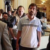 U.S. journalist James Foley (front) arrives at a hotel in Tripoli after being released by the Libyan government in May 2011. Islamic State militants posted a video Tuesday showing Foley being beheaded in retaliation for U.S. airstrikes in Iraq. Social media fight back against gruesome Islamic State propaganda