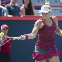 High-speed server: Germany’s Sabine Lisicki plays a shot from Italy’s Sara Errani during their first-round match at the Rogers Cup on Monday. Lisicki won 6-1, 7-5. Lisicki upsets Errani in 1st round of Rogers Cup