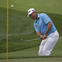 Tied at top: Lee Westwood hits a chip shot on the first hole during the first round of the PGA Championship on Thursday. Westwood tied for PGA lead