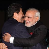 Indian Prime Minister Narendra Modi is welcomed by Prime Minister Shinzo Abe upon his arrival at the Government Guesthouse in Kyoto on Aug. 30. Japan Inc. cautious on India despite prime ministers' love-in