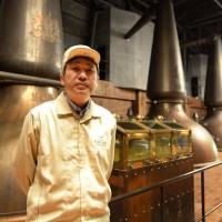 Takeshi Ono, general manager of Suntory Liquors’ Hakushu distillery, stands beside old distillation facilities in Hokuto, Yamanashi Prefecture, on May 13. Japanese whiskey makers in high spirits as accolades roll in