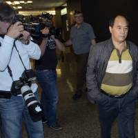 Diran Lin, father of slaying victim Jun Lin, walks to the courtroom for the murder trial of Luka Rocco Magnotta in Montreal on Monday. Magnotta is accused of dismembering Concordia student Jun Lin and mailing the body parts to political parties and schools. Accused admits to killing, pleads not guilty, in Canada dismemberment trial