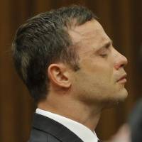Oscar Pistorius reacts in the dock as Judge Thokozile Masipa delivers her verdict during his murder trial in Pretoria on Thursday. From 'Superman' to broken man: Pistorius