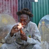 Reggae legend and cannabis legalization advocate Bunny Wailer fires up a pipe stuffed with marijuana during a “reasoning” session in a yard in Kingston on Aug. 28. Jamaica's Rastas ready for decriminalization of pot