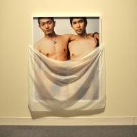 A photograph being exhibited in Aichi Prefecture by artist Ryudai Takano, portraying him and a male model, is veiled with a cloth to highlight a police crackdown on artistic expression showing human genitalia. Artist veils photos showing his genitalia to parry police censorship