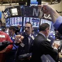Traders work on the floor of the New York Stock Exchange on Wednesday. How well did the Fed's stimulus work?