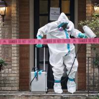 A member of the CG Environmental HazMat team disinfects the entrance to the residence of a health worker at the Texas Health Presbyterian Hospital who has contracted Ebola in Dallas on Sunday. The worker is believed to be the first person to contract the disease in the United States. Can all U.S. hospitals safely treat Ebola?