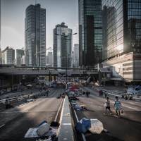 Pro-democracy demonstrators carry their breakfast on a highway in Hong Kong on Friday. Focus: Hong Kong's students tell Xi they don't want a revolution