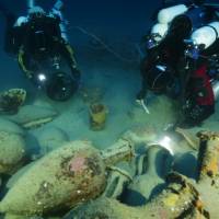 Divers retrieve Greco-Roman artifacts from a ship that sank during the Punic Wars between 218 and 201 B.C. off the Aeolian Island of Panarea near Italy, in this undated photograph provided by Global Underwater Explorers. Ancient Roman shipwreck discovered in deep waters off coast of Sicily