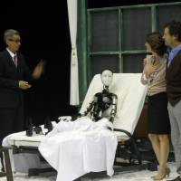 How do you do?: Mr. and Mrs. Samsa (Jerome Kircher and Irene Jacob, right) introduce their transmogrified son Gregor (center) to their lodger Dr. Darmon (Thierry Vu Huu) in this scene from Oriza Hirata’s version of “The Metamorphosis.” Kafka's worm takes a high-tech turn