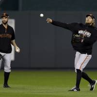 Staying loose: San Francisco's Hunter Pence throws a ball during a workout in Kansas City on Monday night. The Giants will take on the Royals in Game 6 of the World Series on Tuesday. Giants look to close out Royals in Game 6 back in K.C.