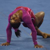 Flower power: Simone Biles performs during the women’s all-around final at the world championships in Nanning, China, on Friday. Biles retains world crown