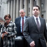 Gilberto Valle (right), the former New York City police officer whose online exchanges about kidnapping and eating women landed him behind bars and earned him tabloid infamy as the “cannibal cop,” leaves court with his mother, Elizabeth Valle, and one of his attorneys, Robert Baum, after he was sentenced to time served Wednesday in New York. Valle had faced a possible life term after his 2013 conviction for kidnapping conspiracy. But U.S. District Judge Paul Gardephe threw out the jury’s guilty verdict earlier this year, clearing the way for Valle to be sentenced on a misdemeanor charge of using a restricted law enforcement database to secretly look up personal information about women he knew. NYC 'cannibal cop' is sentenced to time served