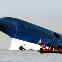 Divers search the wreckage of the Sewol ferry, owned by Chonghaejin Marine Co., 20 km off Jindo Island, South Korea, in April after the vessel sank with hundreds of schoolchildren on board en route to the resort island of Jeju. South Korea ends search for nine still missing in Sewol ferry disaster