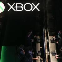 Visitors play video games on Microsoft Xbox consoles during the EGX gaming conference at Earls Court in London on Sept. 25. Xbox back online but PlayStation still down