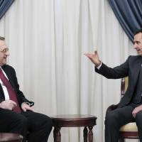 Syrian President Bashar Assad gestures on Dec. 10 while speaking with Russian Deputy Foreign Minister Mikhail Bogdanov in Damascus. The search for a negotiated settlement to the Syrian civil war is gaining steam, as Assad’s forces feel increasingly squeezed on the battlefield and Islamic extremist groups proliferate across the region. Syrian peace talks set to take place in Moscow next month