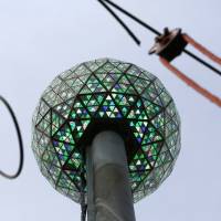 Workers light the Waterford crystal ball during a test for the New Year’s Eve celebration atop One Times Square in New York, Tuesday on Tuesday. The ball, which is 12 feet in diameter and weighs 11,875 pounds, is decorated with 2,688 Waterford crystals and illuminated by 32,256 LED lights. New York gets ready for New Year's Eve celebration