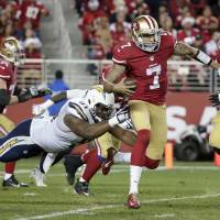Off to the races: San Francisco QB Colin Kaepernick breaks away from San Diego's Kendall Reyes to score on a 90-yard touchdown run in the third quarter on Saturday night. The Chargers defeated the 49ers 38-35 in overtime. Chargers down 49ers in OT