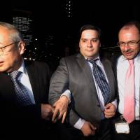 Mark Karpeles (center), at the time CEO of Mt. Gox, is escorted out of the Tokyo District Court on Feb. 28 last year after the world’s largest bitcoin exchange filed for bankruptcy. Mt. Gox chief was thought by U.S. to be Silk Road mastermind