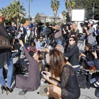Chloe Goins, a model who claims entertainer Bill Cosby drugged and sexually abused her at the Playboy Mansion in 2008, stands before reporters with her attorney Spencer Kuvin (unseen behind her) outside Los Angeles police headquarters after meeting police investigators Wednesday. Kuvin said she came forward after hearing about other women describing abuse by Cosby and realizing she might have a valid criminal case against the comedian. Model who says Cosby sexually abused her in '08 meets with L.A. police