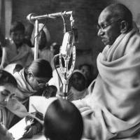 Indian independence leader Mohandas Gandhi squats before a microphone on the second day of his fast in New Delhi in January 1948. U.S. brewery apologizes for using Gandhi's name, image on beer can