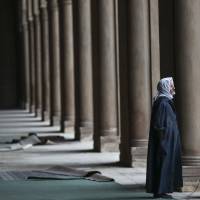 An Egyptian man pauses to think during a visit to the Ibn-Tulun Mosque, one of the oldest mosques in Cairo, on Friday. Violence fuels debate among Muslims over interpretation of their faith