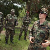 U.S. Army special forces Capt. Gregory, 29 (right), from Texas, who would only give his first name in accordance with special forces security guidelines, speaks with troops from the Central African Republic and Uganda who are searching for Joseph Kony’s Lord’s Resistance Army (LRA), in Obo, Central African Republic in 2012. The Obama administration said Tuesday that it has taken into custody a man claiming to be Dominic Ongwen, a top member of Kony’s group who is wanted by the International Criminal Court, after the man surrendered to U.S. forces. U.S. forces in Africa holding man claiming to be top-level Kony defector