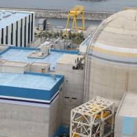 The Shin Kori No. 1 reactor (right) and No. 2 reactor of state-run utility Korea Electric Power Corp. are seen in Ulsan, South Korea, on Sept. 3, 2013. The hacking of South Korea’s nuclear operator means its second-oldest reactor may be shut permanently due to safety concerns, said several nuclear watchdog commissioners, raising the risk that other aging reactors may also be closed. Fukushima meltdowns pervade Korean debate on extending reactor life