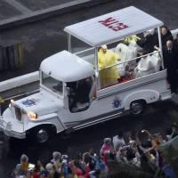 Pope Francis waves to the crowd as he leaves in his popemobile after attending a Mass at Rizal Park in Manila on Sunday. An estimated 6 million people turned out to see him along the routes he took in the modified white Jeepney and at his final Mass. Record 6 million faithful turn out for Pope Francis' final day in Manila